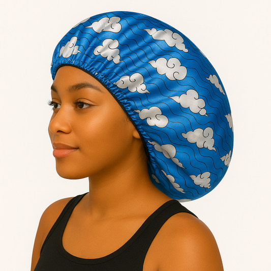 Woman wearing a blue satin bonnet with cloud pattern, showcasing the Water Sakonj - Silky Crown Bonnet.